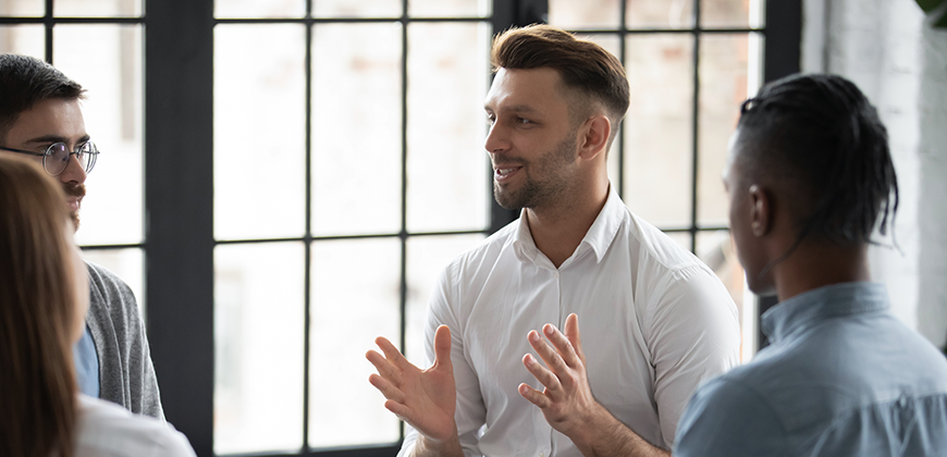 Man talking to a small group of colleagues