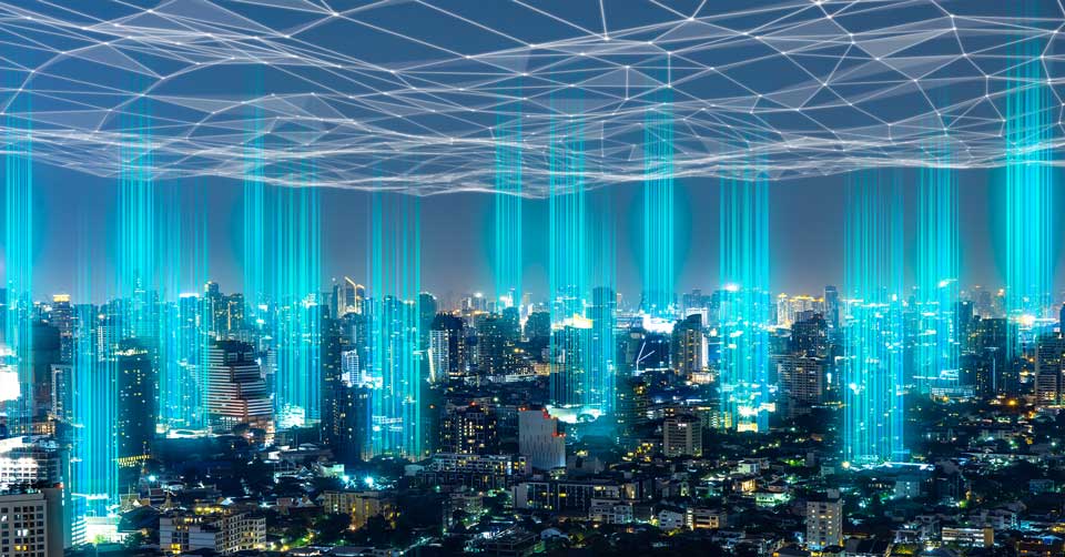 A city skyline illuminated by a network of blue lines representing digital connectivity.