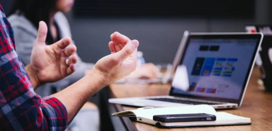 speaking with their hands at a meeting
