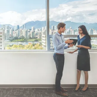 Urban planners standing by a city landscape discussing the cityscape