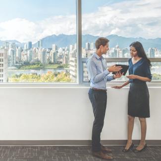 Urban planners standing by a city landscape discussing the cityscape