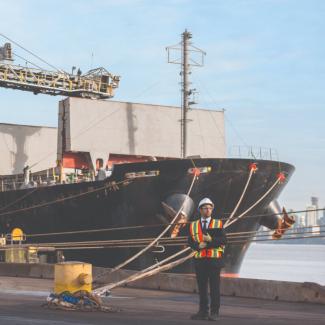 Man standing next to ship