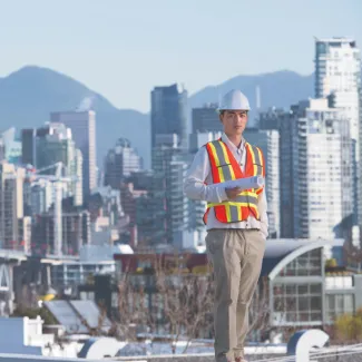 Urban planner standing by the city