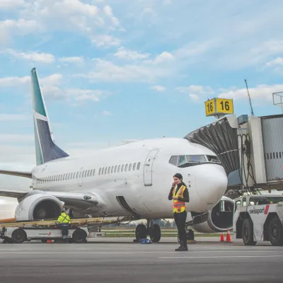 Project manager standing by an airplane