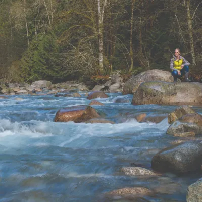 Woman squatting by the river