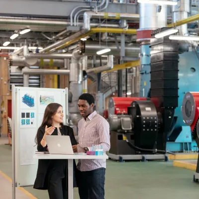 Engineers discussing sustainability solutions in a factory